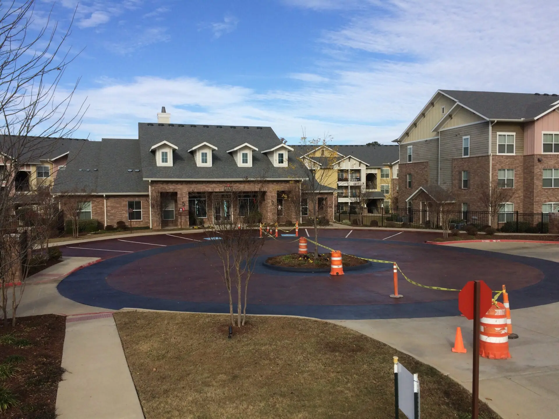 A view of an apartment complex with orange cones.
